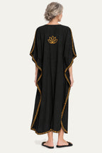 Model wearing the black and mustard Kashmir cotton butterfly kaftan, back view with the lotus motif