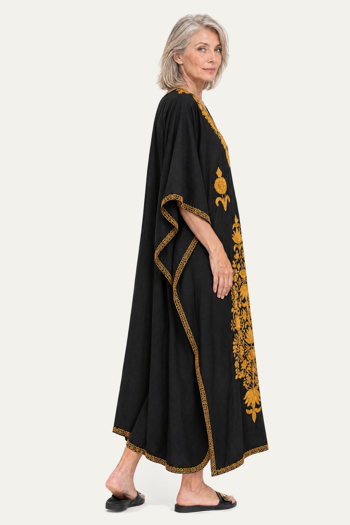 Model wearing the black and mustard Kashmir cotton butterfly kaftan, side view showing the drape